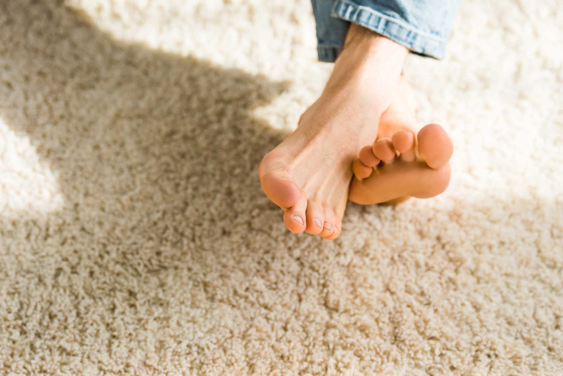 Image of bare feet on clean carpet free of water stains